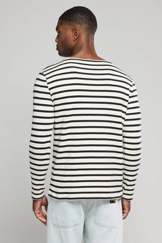 Man wearing a long-sleeve navy and white striped shirt, viewed from the back