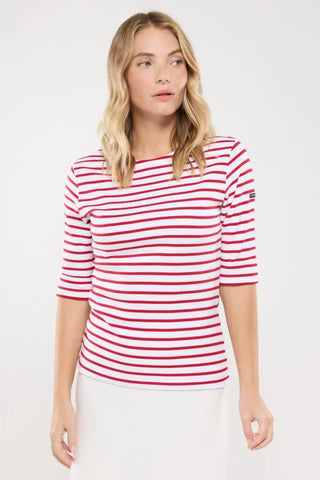 Woman wearing a red and white striped boat neck top with three-quarter sleeves