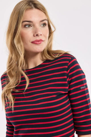 Woman wearing a navy and red striped long-sleeve shirt, casual fashion style