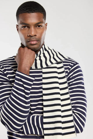 Man wearing navy and white striped sweater and matching striped scarf