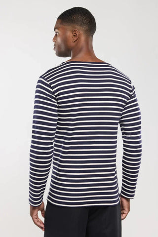 Man wearing a navy and white striped long sleeve shirt, back view, casual style