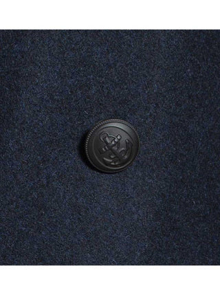 Close-up of navy wool coat with embossed anchor button detail for men