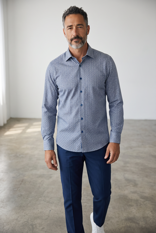 Man wearing a Bugatchi James long-sleeve navy blue circle print OoohCotton shirt with a pointed collar.
