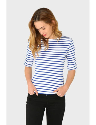 Woman wearing blue and white striped Breton shirt with 3/4 sleeves and black pants