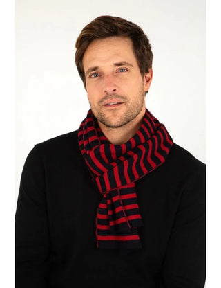 Man wearing a black sweater and a red and navy blue striped wool scarf