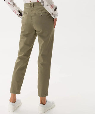 Woman wearing vintage-style khaki cotton pants, cropped fit, back view, casual fashion.