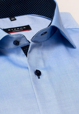 Light blue men's long sleeve shirt with dark buttons and contrasting dotted inner collar