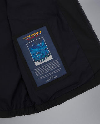 Close-up of Typhoon 20000 navy vest interior with branded label and blue graphic patch