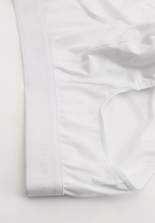 White men's slip briefs with elastic waistband on a plain background